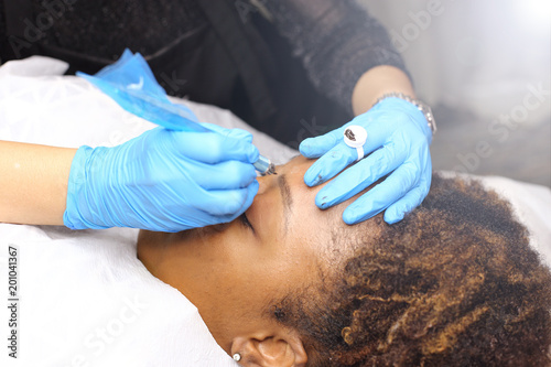 applying Tottoo, Brow Microblading to customer eyebrows