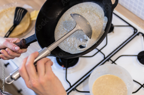 Baking pancakes on a cast-iron frying pan