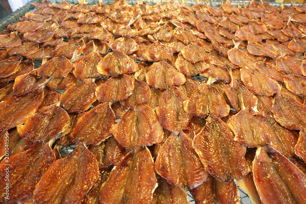 Row of many Dried fish mackerel Spread on the net. Seafood processing for sale at Seafood local Market in Chonburi, Thailand Row of many Dried fish mackerel Spread on the net. Seafood processing for sale at Seafood local Market in Chonburi, Thailand