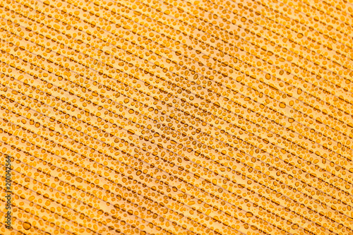 Drops of water on orange plastic as background
