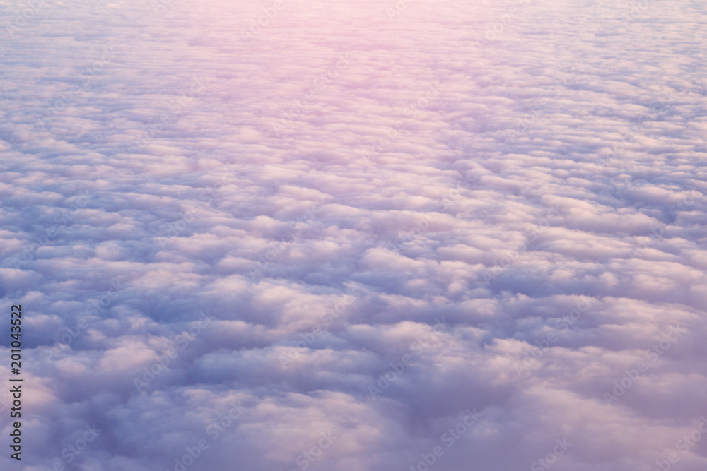 above the clouds, top view, sunlight, lilac clouds, concept travel above the clouds, top view, sunlight, lilac clouds, concept travel