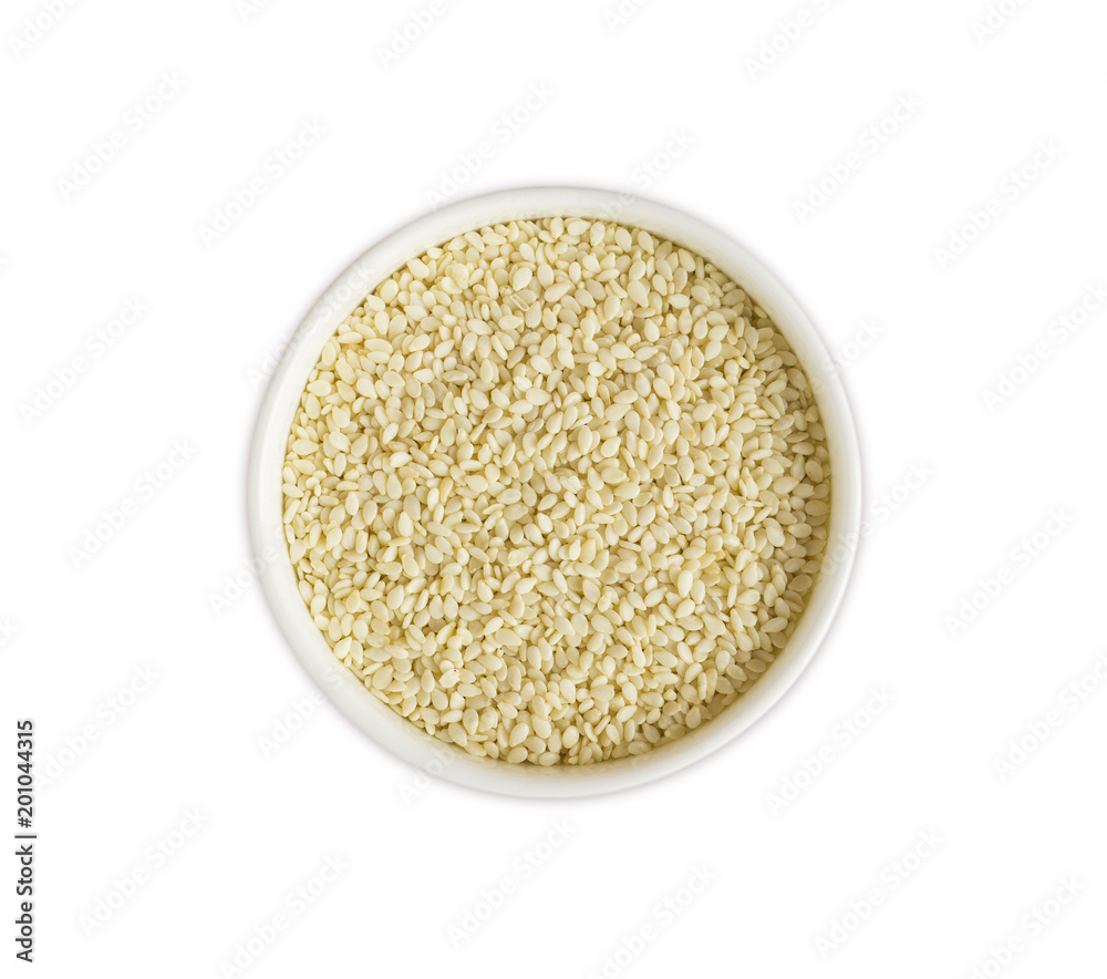 Sesame on white background. Top view. White sesame in a bowl isolated on white background. Sesame with copy space for text. Sesame on white background. Top view. White sesame in a bowl isolated on white background. Sesame with copy space for text.