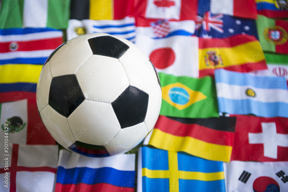 Close up view of a football on a background of international flags Close up view of a football on a background of international flags
