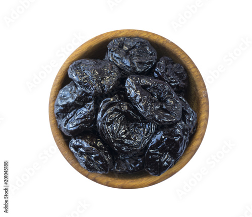 Dried prunes isolated on a white background. Dried prunes in a bowl on white background. Dried prunes with copy space for text. Top view