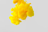 close up view of bright yellow paint splash in water isolated on gray