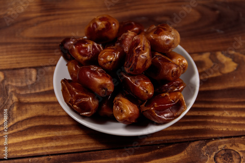 Dried dates fruit on wooden table