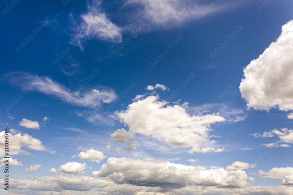 white fluffy clouds on blue sky at sunny day white fluffy clouds on blue sky at sunny day