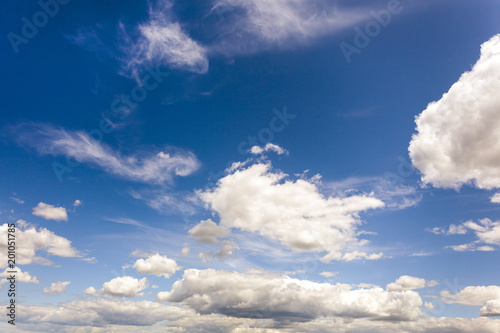 white fluffy clouds on blue sky at sunny day