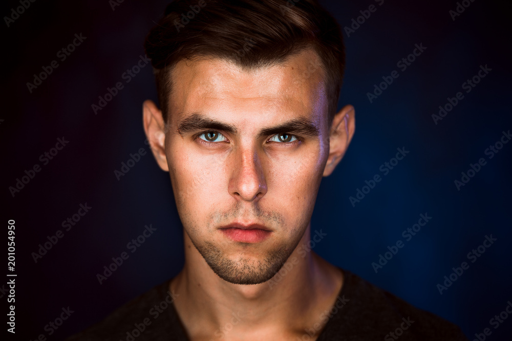 Portrait of a young man on a dark background