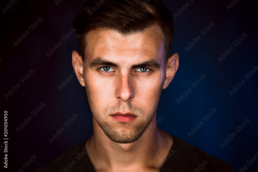 Portrait of a young man on a dark background Portrait of a young man on a dark background