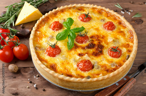 Freshly baked homemade pie quiche Lorraine on a wooden table