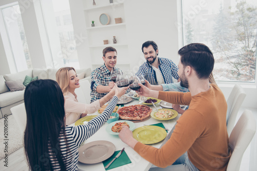 Six best  attractive  stylish  positive  friendly friends celebrating holiday indoor in house flat apartment clinking glasses with red wine sitting at table with homemade dishes enjoying holiday