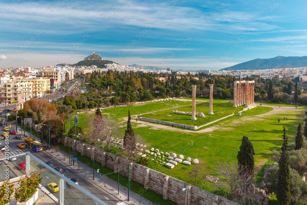 Aerial city view with Ruins and a columns of the Temple of Olympian Zeus, Mount Lycabettus in the background, Athens, Greece
