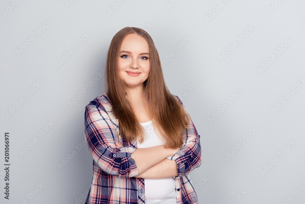 Young woman in flannel shirt stands with arms crossed Stock Photo | Adobe  Stock