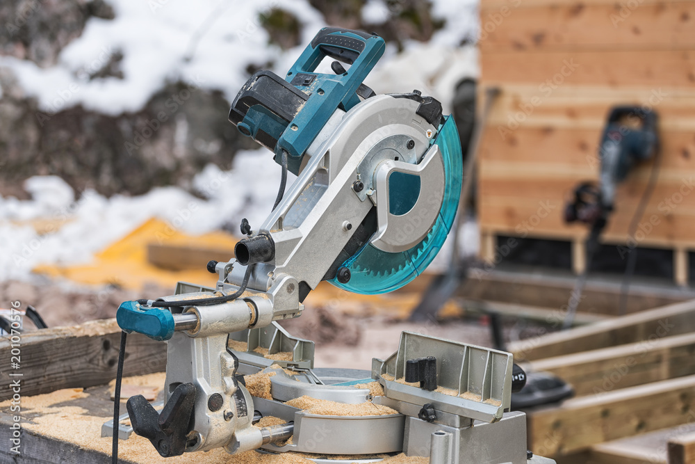 Fototapeta premium The lumberjack cutting the timber for lumber by circular saw.