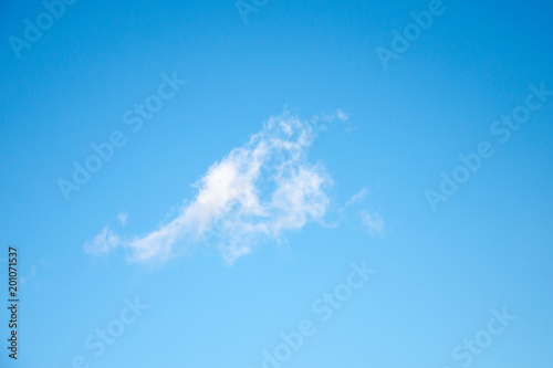 Blue sky with one light cloud