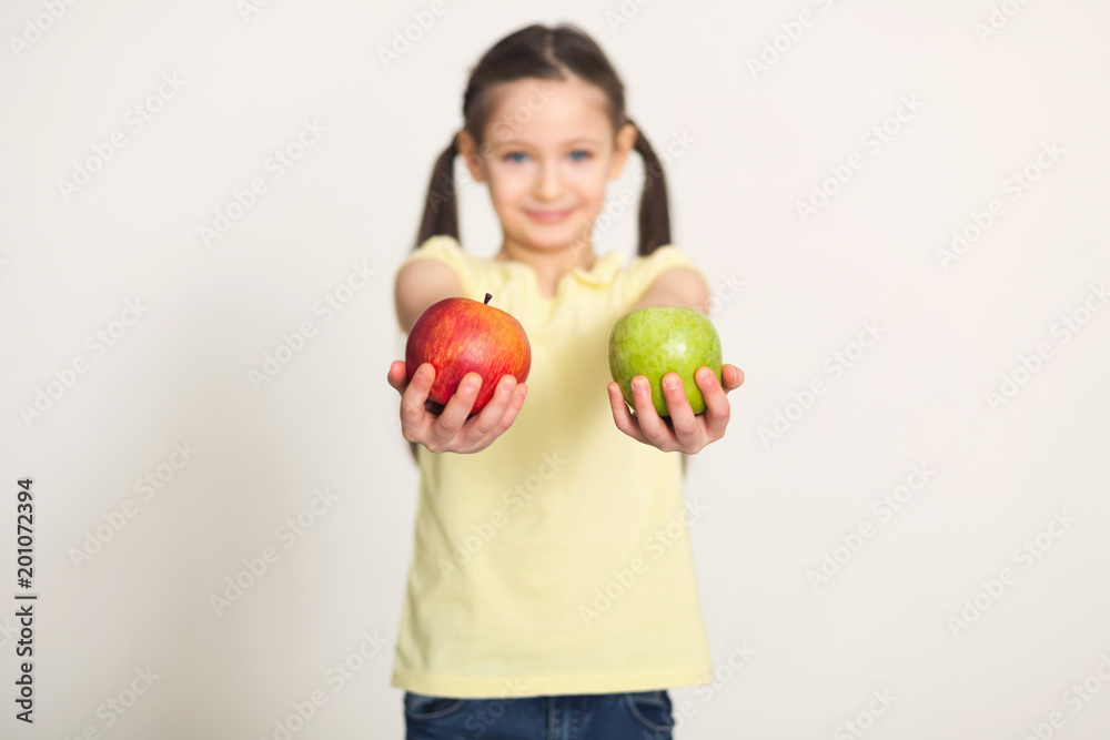 Pretty cute little girl with apples over white background Pretty cute little girl with apples over white background