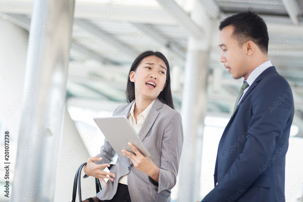 Young businesswoman holding papers talking with a businessman with anger, Boss found a mistake in documentation. Work failure concept. Young businesswoman holding papers talking with a businessman with anger, Boss found a mistake in documentation. Work failure concept.