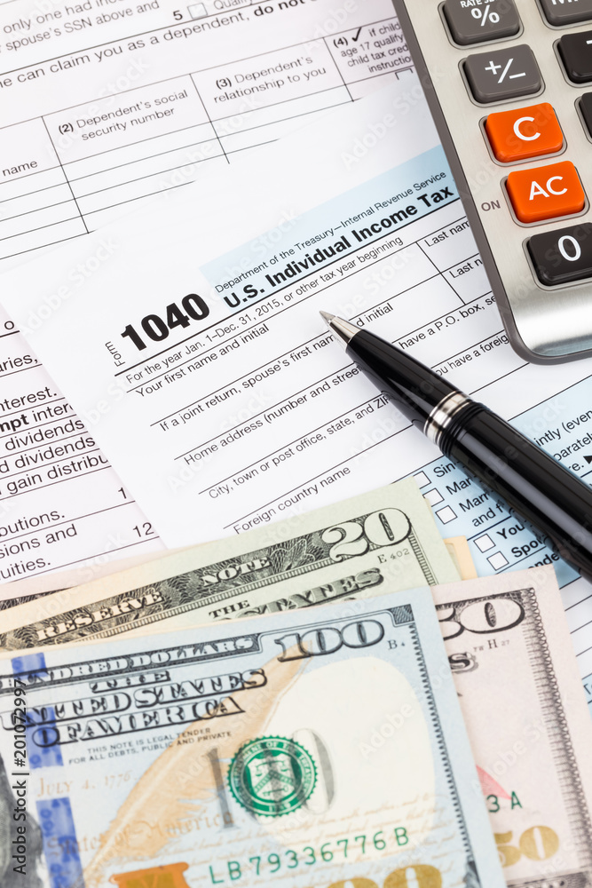 Fototapeta premium Tax form with calculator, pen, and dollar banknote
