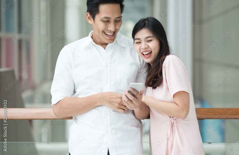 Fototapeta premium Happiness Two people using smart phones.