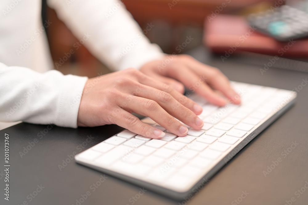 financial advisor typing on keyboard while sitting at office and working on computer financial advisor typing on keyboard while sitting at office and working on computer