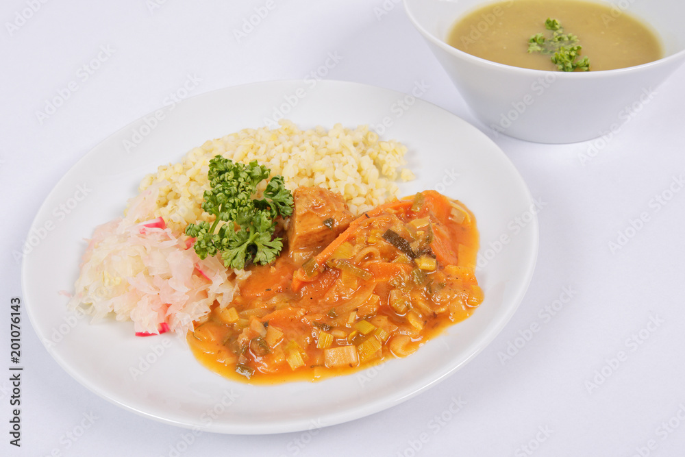 Seitan goulash with bulgur on a white Seitan goulash with bulgur on a white
