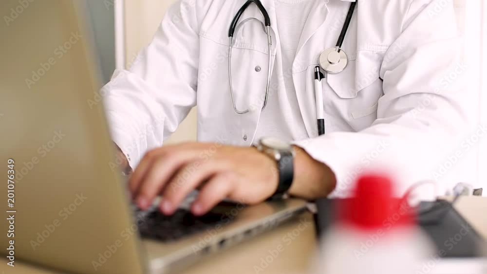 Doctor Typing On Laptop
