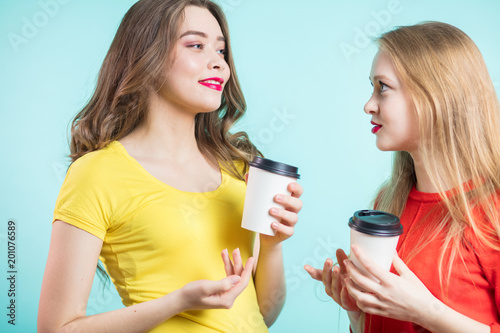 Two smiling students having a cup of coffee and fun to talk