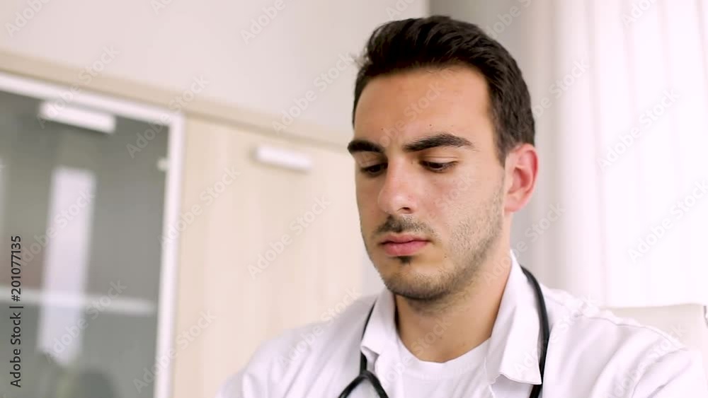 Close Up Portrait Of Young Doctor Who Working On Laptop Close Up Portrait Of Young Doctor Who Working On Laptop