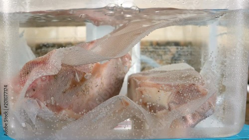 Two new york strip steaks in sous vide bath photo