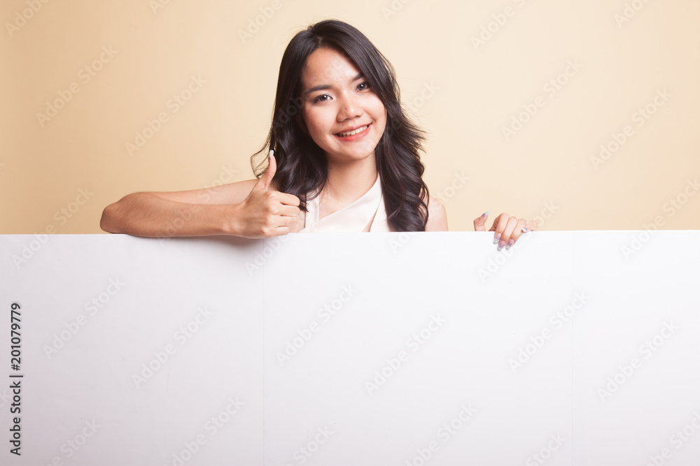 Young Asian woman show thumbs up with blank sign. Young Asian woman show thumbs up with blank sign.