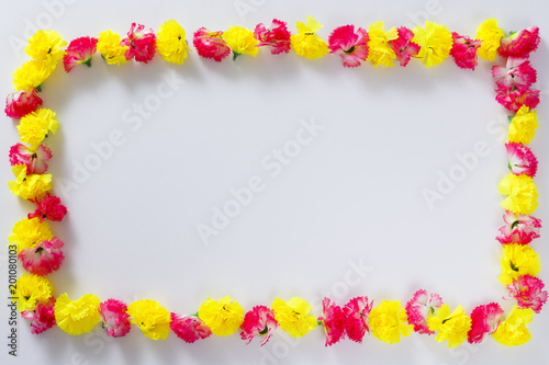 Flowers composition. Frame made of pink and yellow flowers.
