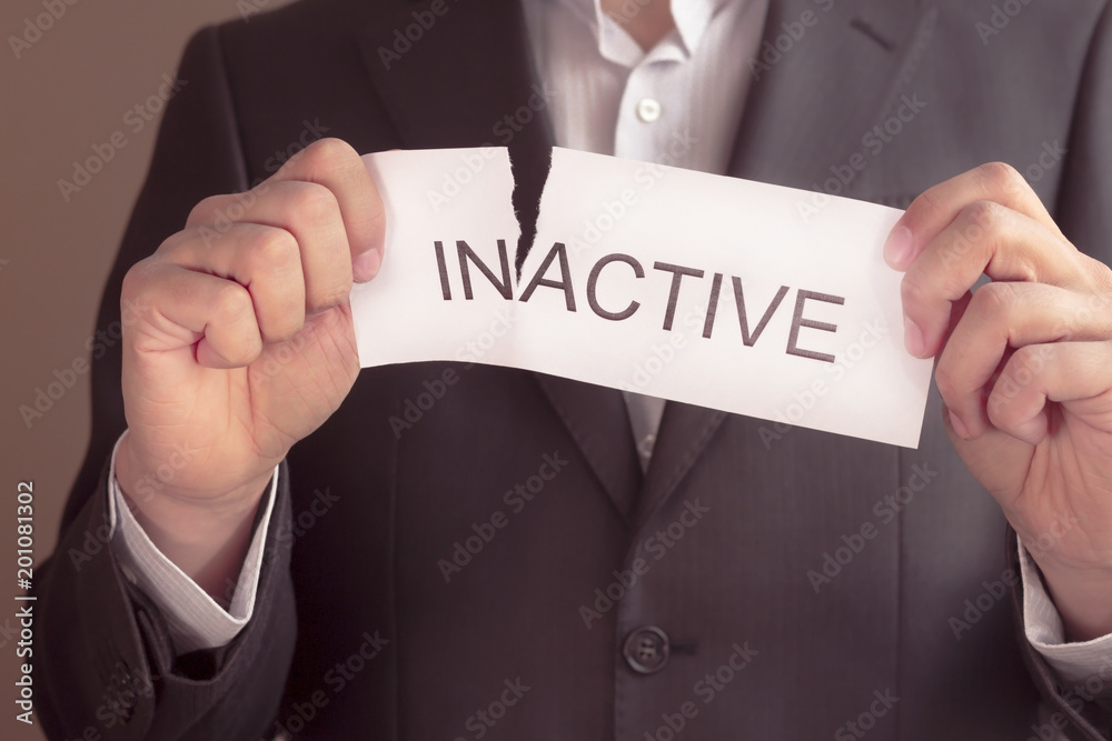 inactive is active concept. Hand holding card with text inactive, tearing off word in. Conceptual image of changing position from inactive to active. inactive is active concept. Hand holding card with text inactive, tearing off word in. Conceptual image of changing position from inactive to active.