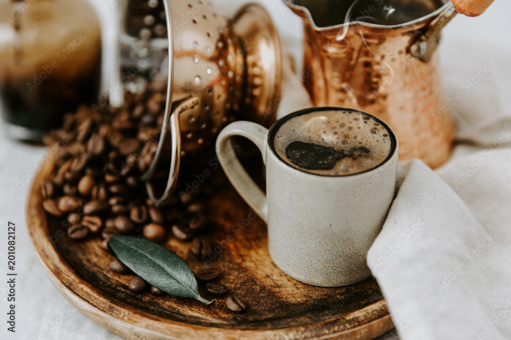 Turkish Coffee Pot and Coffee beens on linen table Turkish Coffee Pot and Coffee beens on linen table