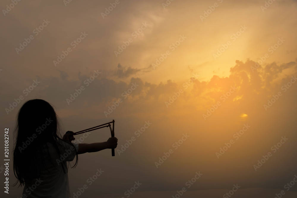 A girl silhouette pretend to shoot forward .seeds for growth in the wild concept. A girl silhouette pretend to shoot forward .seeds for growth in the wild concept.