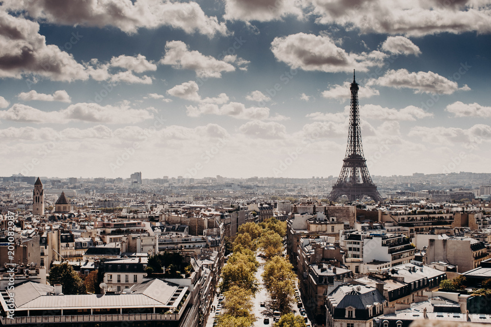 Panoramic view of capital of France Paris with Eiffel towel from above, beautiful cityscape, cloudy blue sky. Day with wonderful historical landsmark and builduings. Nice attractive city for tourists