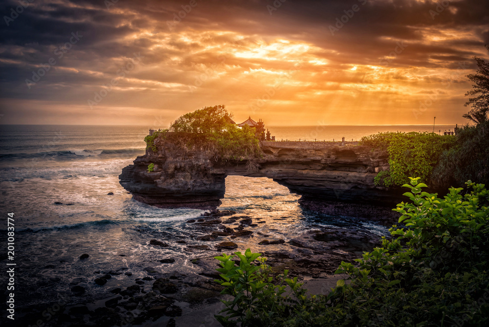 Tanah Lot Temple on sea at sunset in Bali Island, Indonesia.