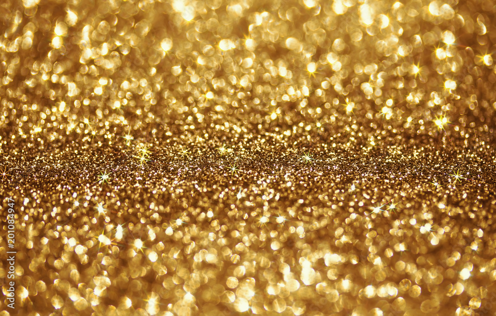 Golden beautiful festive shiny background of bright sparks and shimmering stars and circles Golden beautiful festive shiny background of bright sparks and shimmering stars and circles