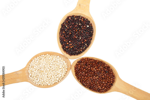 Black red white quinoa seeds in wooden spoon isolated on white background. Top view