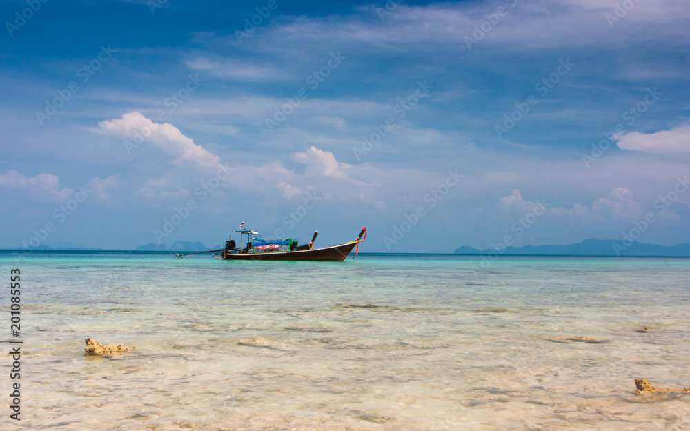 Traditional thai longtail boats on the beach of Ko Ngai, Koh Lanta, Thailand.