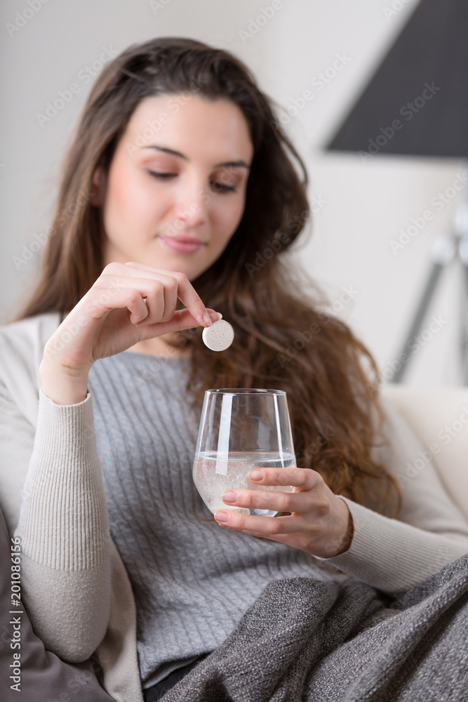 Unhealthy sick woman takes pill with glass of water Unhealthy sick woman takes pill with glass of water