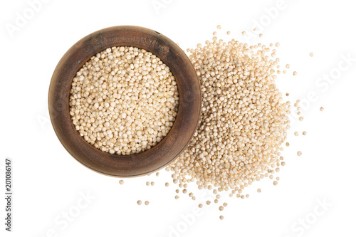 red quinoa seeds in wooden bowl isolated on white background. Top view