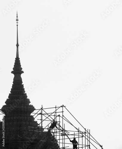 scaffolding and the technician at the pagoda in bangkok  thailand - monochrome background
