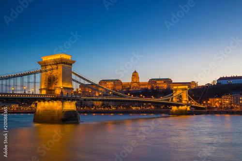 Budapest, Hungary - Illuminated Szechenyi Chain Bridge over River Danube and Buda Castle Royal Palace at blue hour with clear blue sky