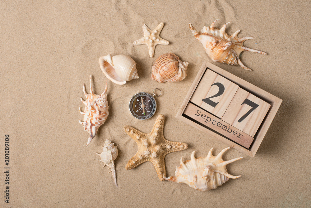 Calendar from September 27 with a compass, sand and seashells. International Tourism Day Calendar from September 27 with a compass, sand and seashells. International Tourism Day