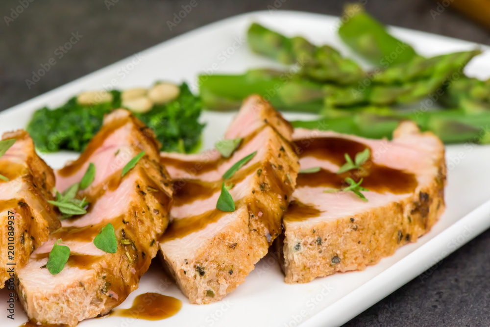 Roasted pork tenderloin and asparagus - close up