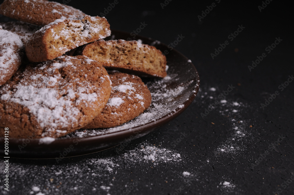 oatmeal cookies on a black table in castor sugar oatmeal cookies on a black table in castor sugar