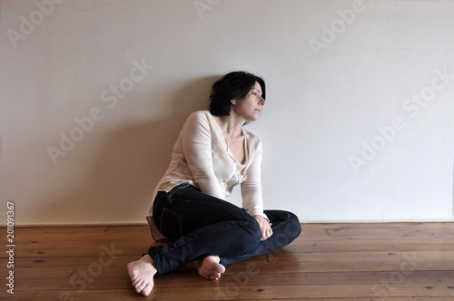 a sad woman on the floor of her house