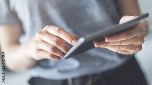 Woman using digital tablet close up view