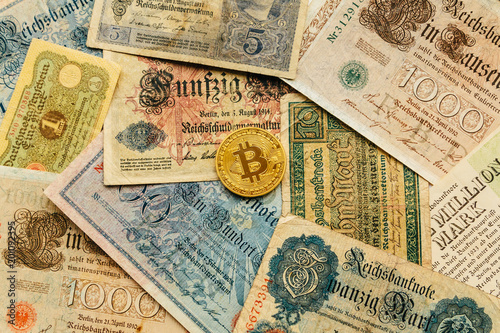 Bitcoin with old deutsch money. Cash Inflation. Cryptocurrency concept background. Closeup with copy space.